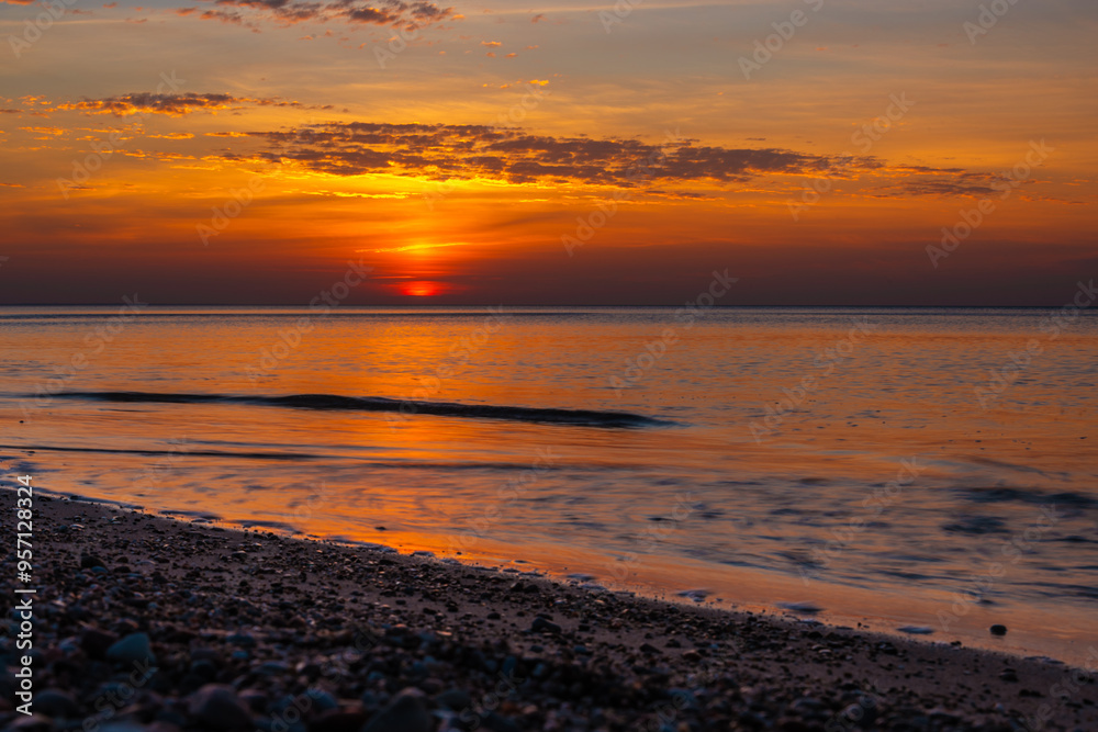 Sandy beach with pebbles of Baltic Sea on Curonian Spit at sunset. Kaliningrad region. Russia