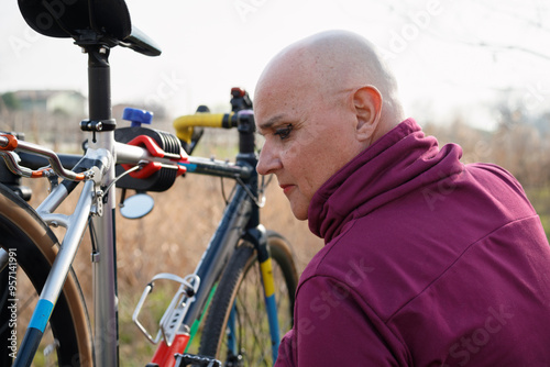 Non binary cyclist near their bike photo