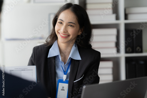 Confident Professional: A successful businesswoman smiles warmly while engaging in a professional conversation, showcasing her confidence, expertise, and approachable demeanor.   photo