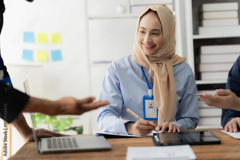 © Kritdanai - Engaged Muslim Professional in Collaborative Workplace Discussion © Kritdanai - Engaged Muslim Professional in Collaborative Workplace Discussion