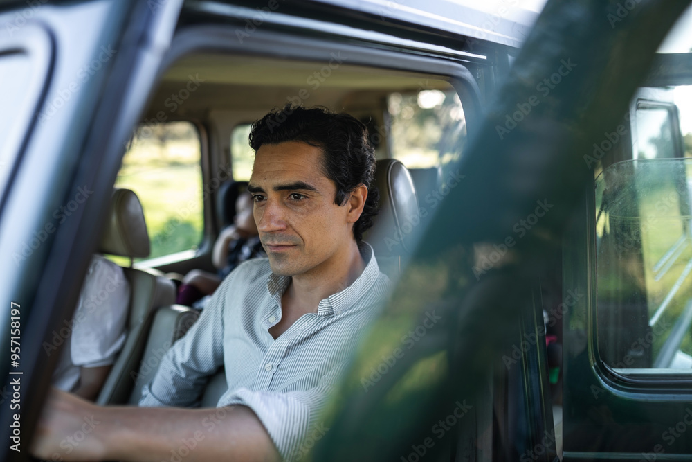 young man getting into his car to go on a trip