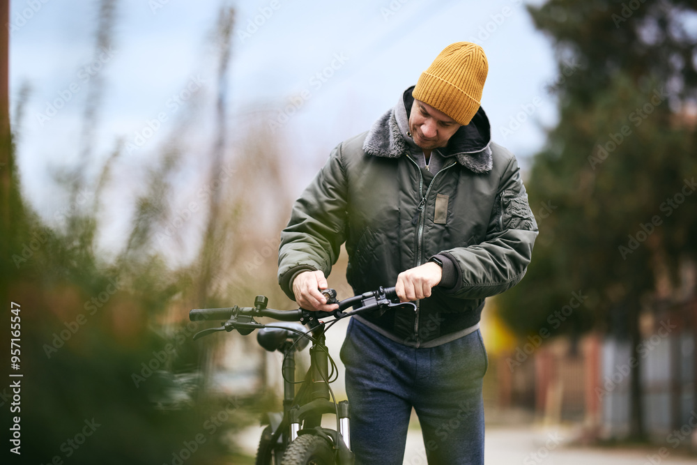 Fototapeta premium Man Walking Bike Down Street