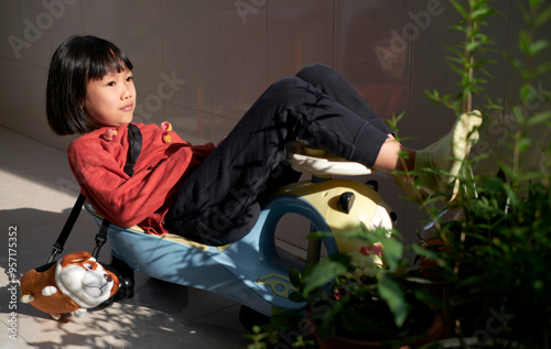 Chinese girl lying at home playing with toys photo