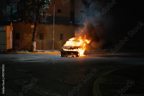 A car on fire in the street 