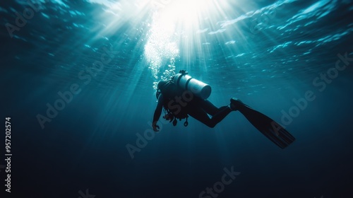 A lone scuba diver floats horizontally deep underwater, surrounded by the vastness of the ocean, with sunlight filtering through the surface, creating a mystical underwater ambiance.