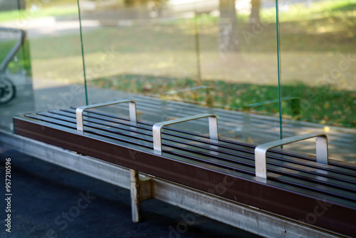 bus stop bench features metal ridges designed deter sleeping, highlighting societal attitudes towards homelessness public space usage. It reflects a complex relationship between comfort and exclusion photo