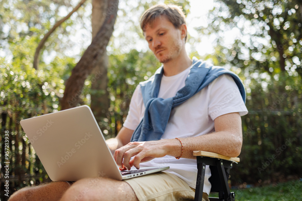 Serious freelancer working on laptop Serious freelancer working on laptop