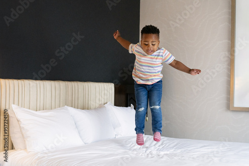 Child Jumping on Hotel Bed