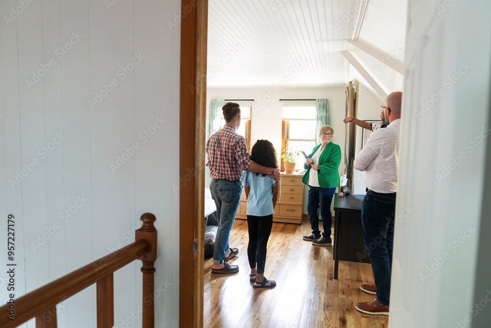Family Discussing Bedroom Details with Real Estate Agent Family Discussing Bedroom Details with Real Estate Agent