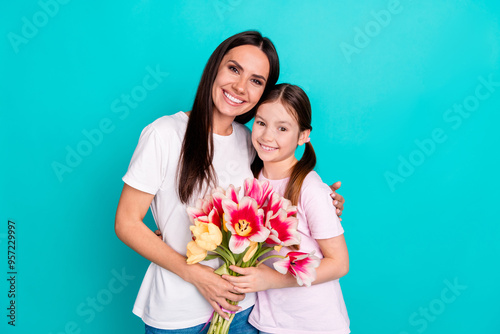 Photo of cheerful lovely adorable girl hugging mommy mother day festive event isolated on cyan color background