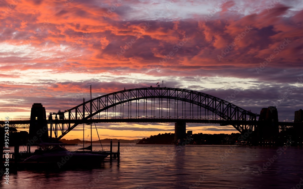 Fototapeta premium Harbour Bridge Sunset Silhouette: Dramatic Sydney Skyline Background