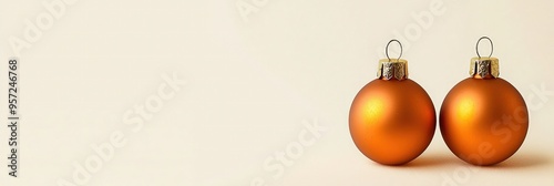 Cream holiday card adorned with subtle orange ornaments, elegantly simple.