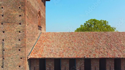 Italian castle an artistic historical cultural heritage. Visconti castle of Pavia with its walls, bridge, moat, towers. Structure that attracts tourists traveling to discover the wonders of Italy. photo