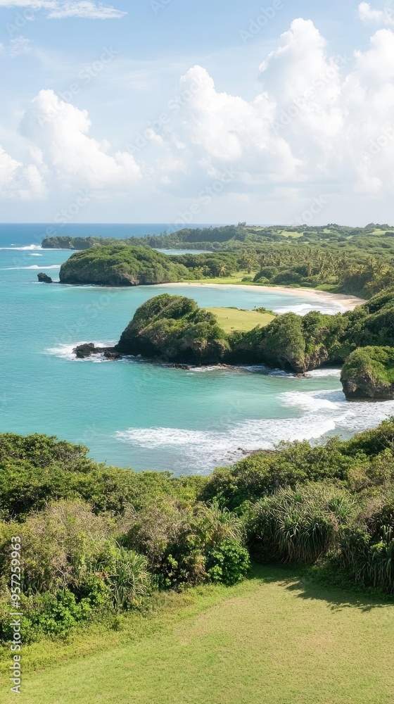 Obraz premium Experience the enchanting beauty of the Hawaiian coast, where emerald green cliffs meet vibrant blue waters and lush greenery flourishes under fluffy clouds, creating a serene paradise