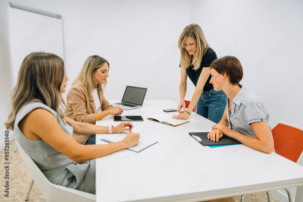 Businesswomen discussing startup project in office Businesswomen discussing startup project in office