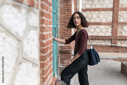 Female student opening university door photo