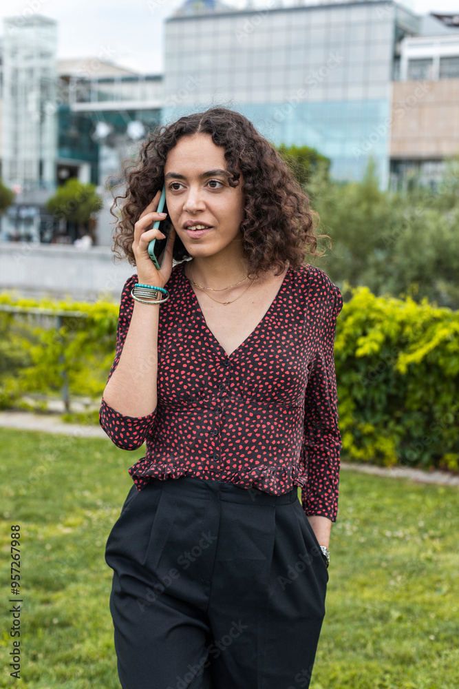 Businesswoman with curly hair on phone call