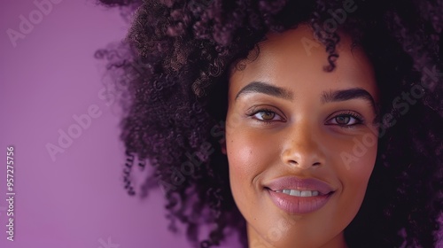 An Afro woman with natural curly hair, smiling softly