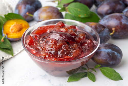 Damson plum jam and fresh plums photo