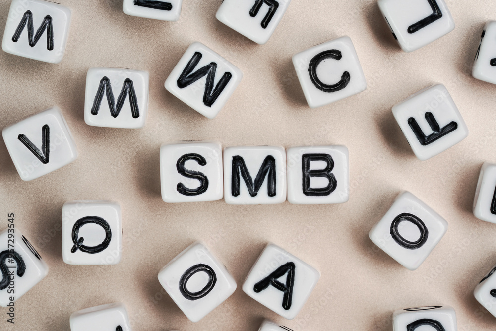 Small white and black bead cubes on a board, letters in middle spell SMB - Small to medium business Small white and black bead cubes on a board, letters in middle spell SMB - Small to medium business