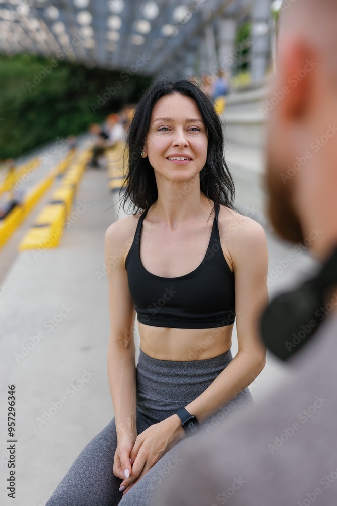 Dark-haired fitness woman discussing workout results with boyfriend Dark-haired fitness woman discussing workout results with boyfriend