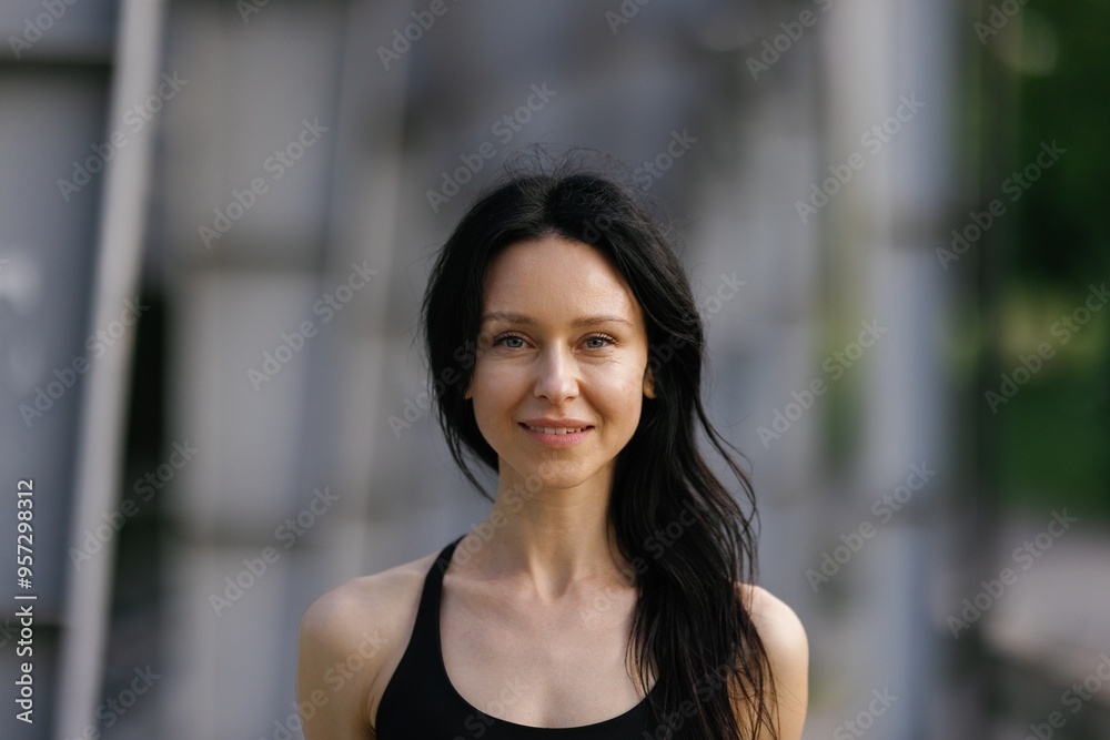 Portrait of young fitness woman with black hair in black sports bra Portrait of young fitness woman with black hair in black sports bra