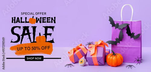 Composition with shopping bag, gift boxes, bats and pumpkin for Halloween on purple background photo