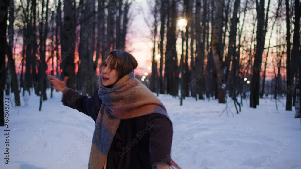 Dancer woman dance in winter park,, dancing in snow forest, north new year christmas mood. Listening to music on the phone using headphones Dancer woman dance in winter park,, dancing in snow forest, north new year christmas mood. Listening to music on the phone using headphones