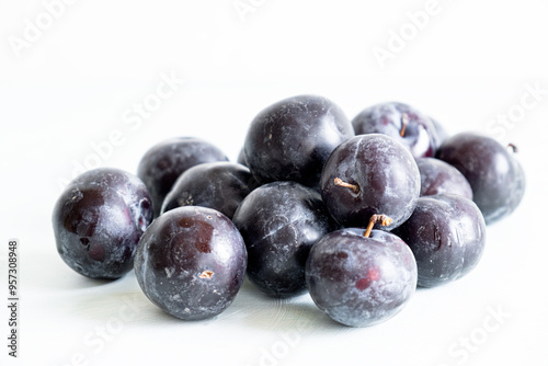 Ripe plums on a white background