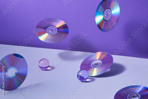 Floating CDs And Glass Orbs On Purple Background photo