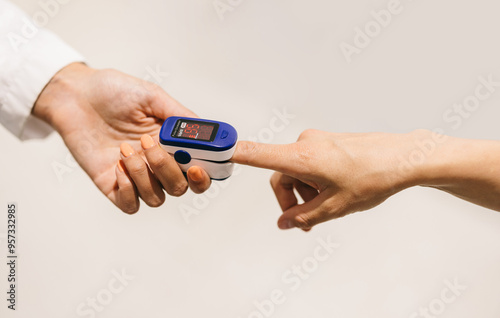 Finger pulse oximeter used to measure oxygen level 