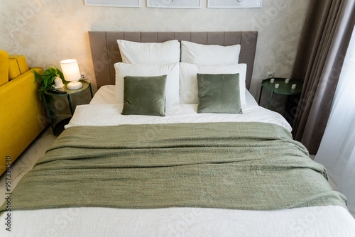 Wallpaper Mural A bed with white sheets and green pillows in a yellow couch room Torontodigital.ca