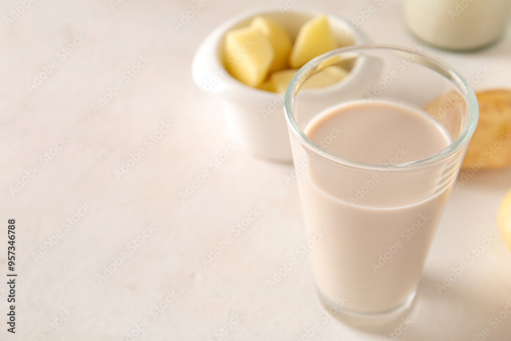 Glass of tasty potato milk on light background Glass of tasty potato milk on light background