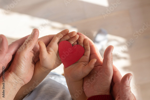 multi generation family concept, love and care, hands holding heart