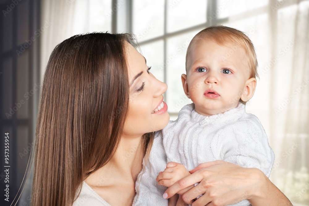 a mother with cute newborn baby hugs and kisses a mother with cute newborn baby hugs and kisses