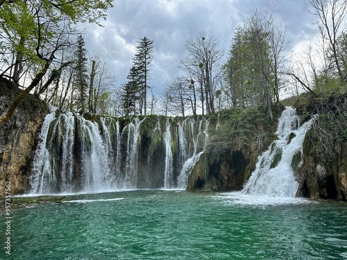 A mesmerizing cascade of water rushes down a rugged rock face in Plitvice, Croatia