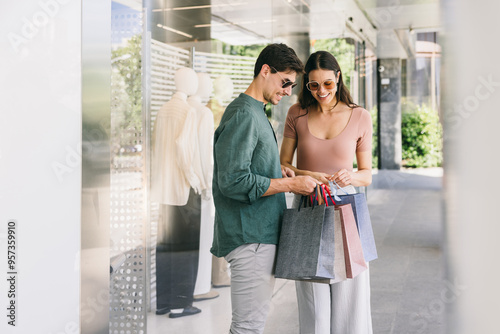 Couple Shopping in Azca, Madrid with Bags Outside Store photo