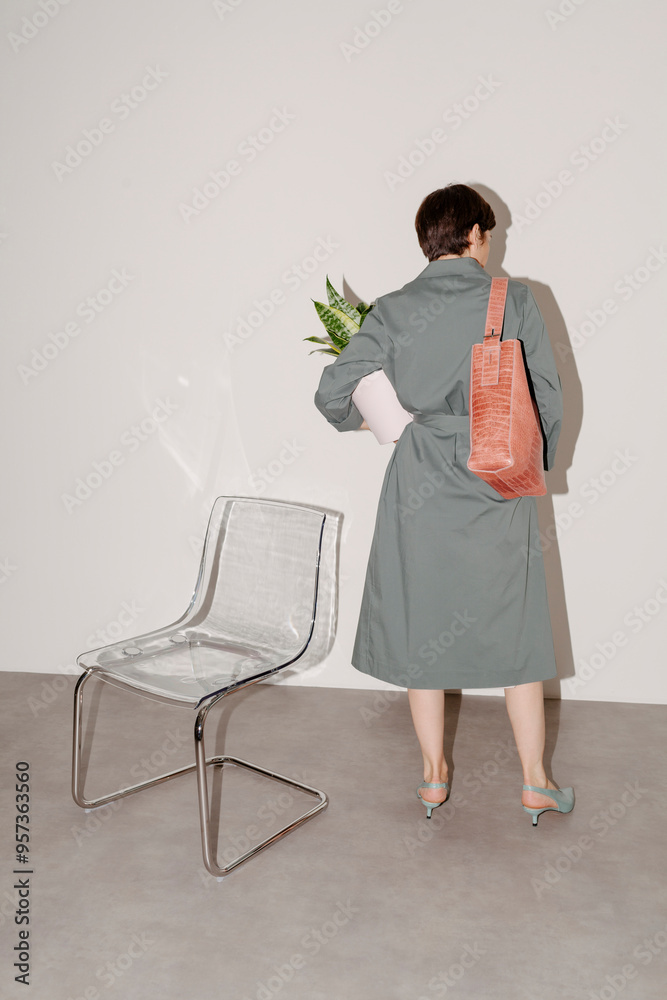 Modern Woman Holding Plant in Minimalist Setting Modern Woman Holding Plant in Minimalist Setting