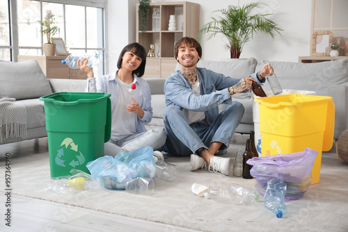 Young couple with garbage c...