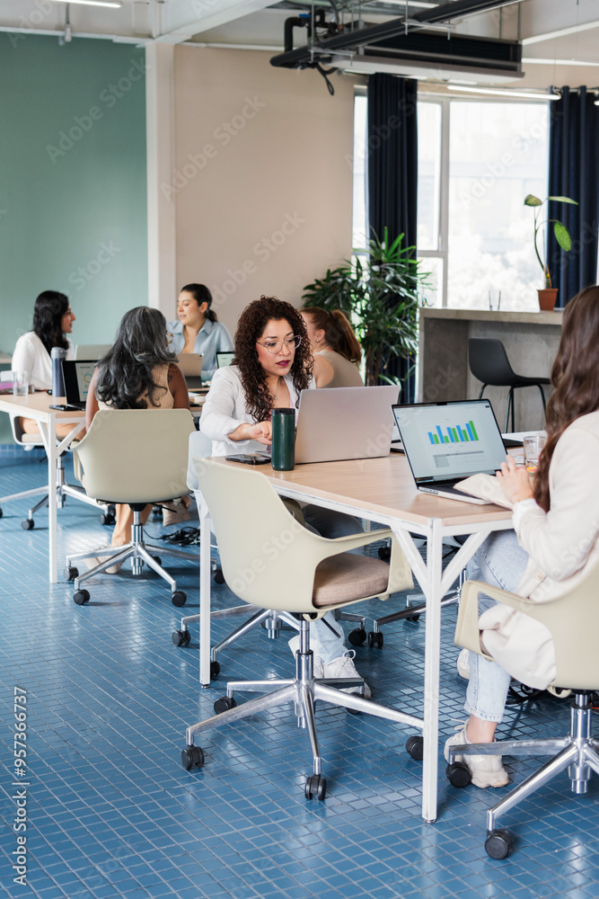 Women working in a coworking space. Women working in a coworking space.