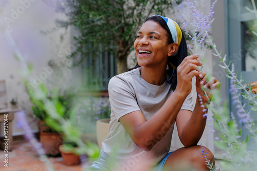 Woman gardening and enjoying lavender scent in a sunny garden photo