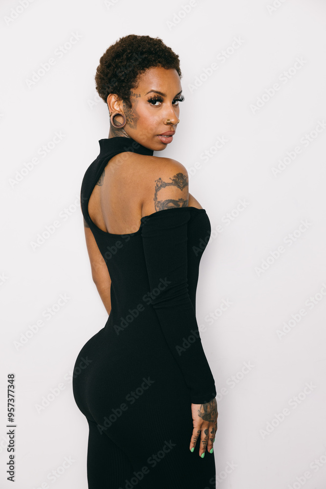Woman in a black dress with tattoos and piercings Woman in a black dress with tattoos and piercings