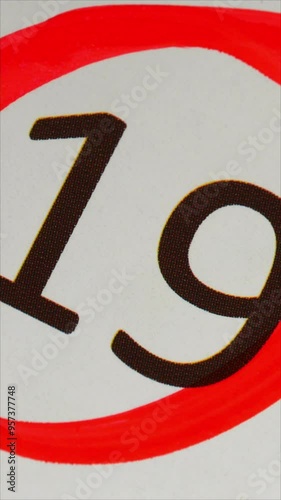 19 - Marking the date in the calendar with a red marker. The nineteenth day of the month, the hand encircles date 19 on the calendar. Vertical.