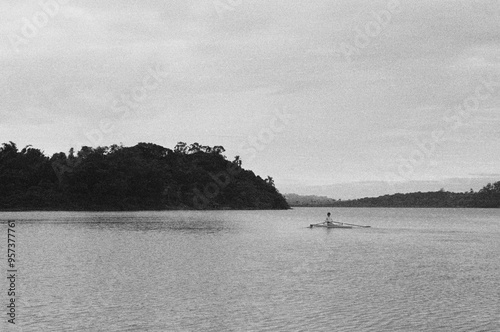 Monochrome shoot of a man alone in a boat  photo