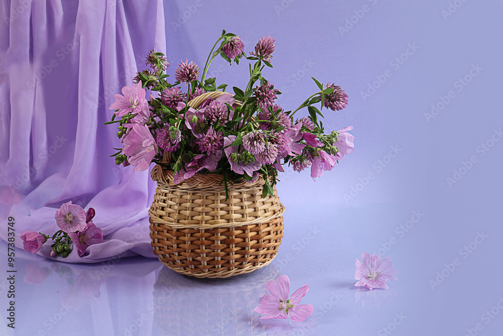 Bouquet of pink flowers in a wicker basket on a pastel background Bouquet of pink flowers in a wicker basket on a pastel background