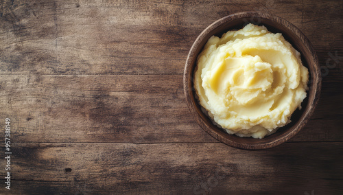 Homemade mashed potatoes in a rustic bowl on a wooden table  photo