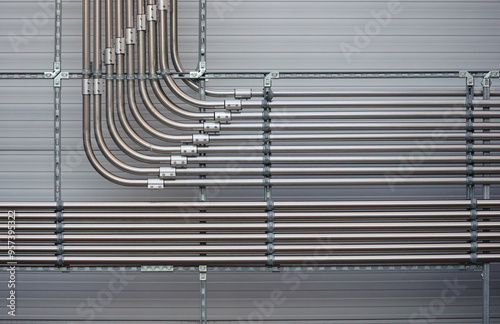 A series of pipes are hanging from the ceiling, with some 