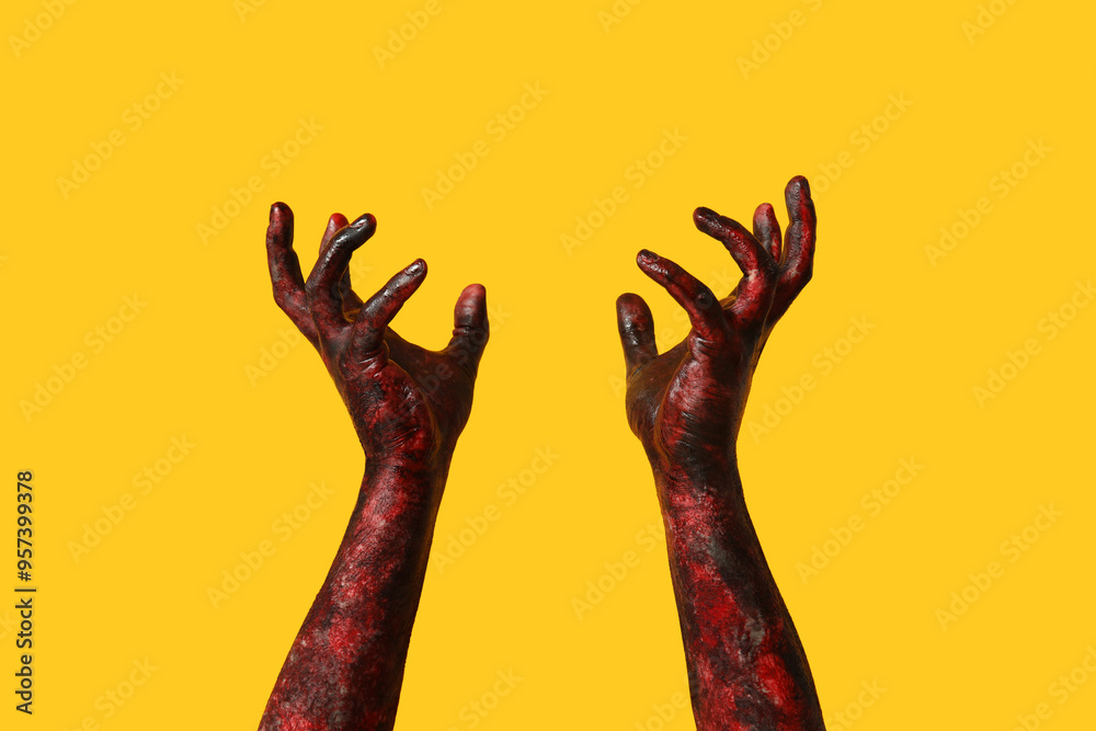 Hands of zombie on yellow background. Halloween celebration Hands of zombie on yellow background. Halloween celebration
