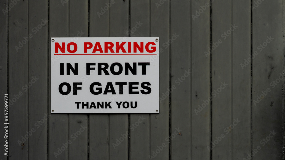No Parking Sign on a Gray Wooden Gate No Parking Sign on a Gray Wooden Gate