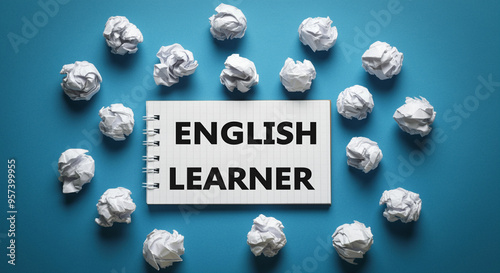 Notepad with English learner text surrounded by study materials for effective learning photo